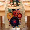 A bohemian polka dot table runner featuring colorful circular patterns and floral accents on a wooden table.