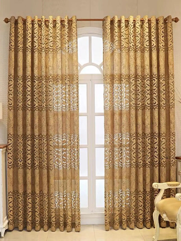 A pair of beige hollow perforated curtains with ornate gold patterns hanging in a doorway.