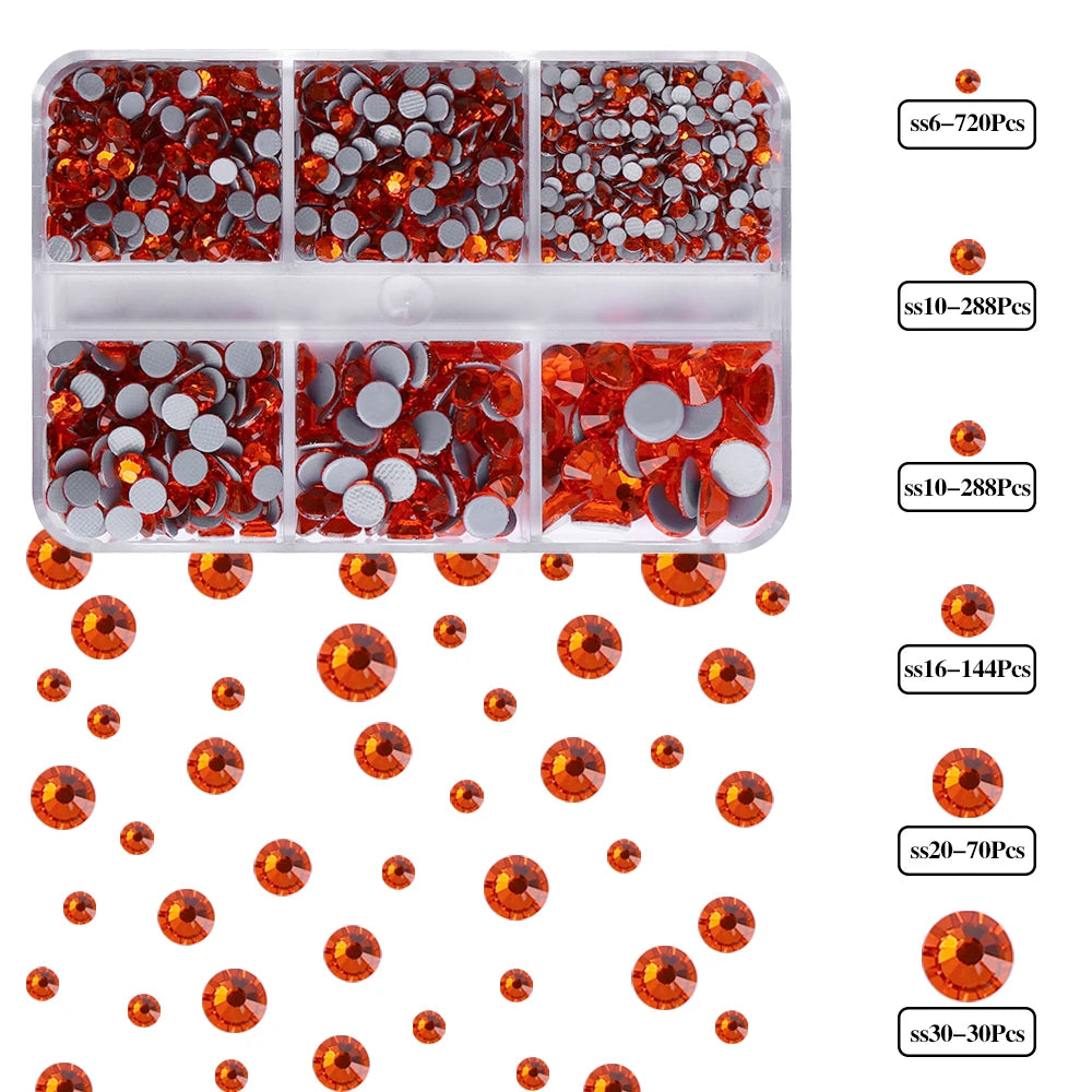 A clear plastic tray holds various sizes of orange and red glass rhinestones for crafts and apparel.