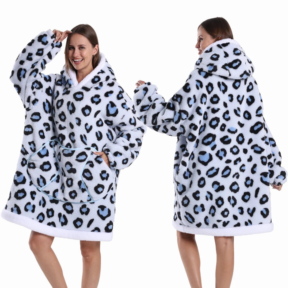 A woman models an oversized leopard print fleece hoodie with a white sherpa lining.