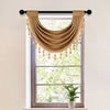 A brown European style window curtain valance with tassels hanging over a window.