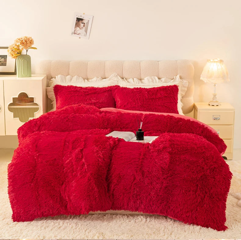 A vibrant red plush duvet cover set displayed on a bed with white linens and bedside tables.
