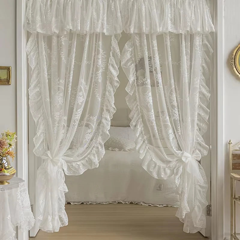 White sheer curtain with ruffled lace trim and vintage floral design hanging in a room.