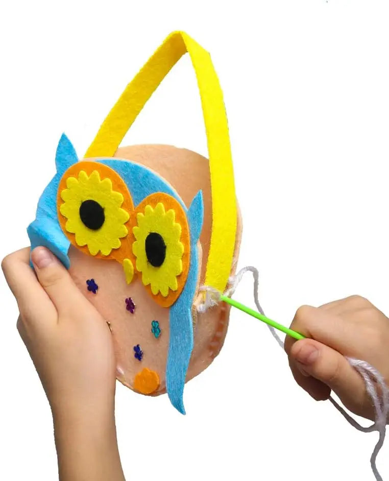 A hand is using a plastic sewing needle with a large eye to work on yarn craft.