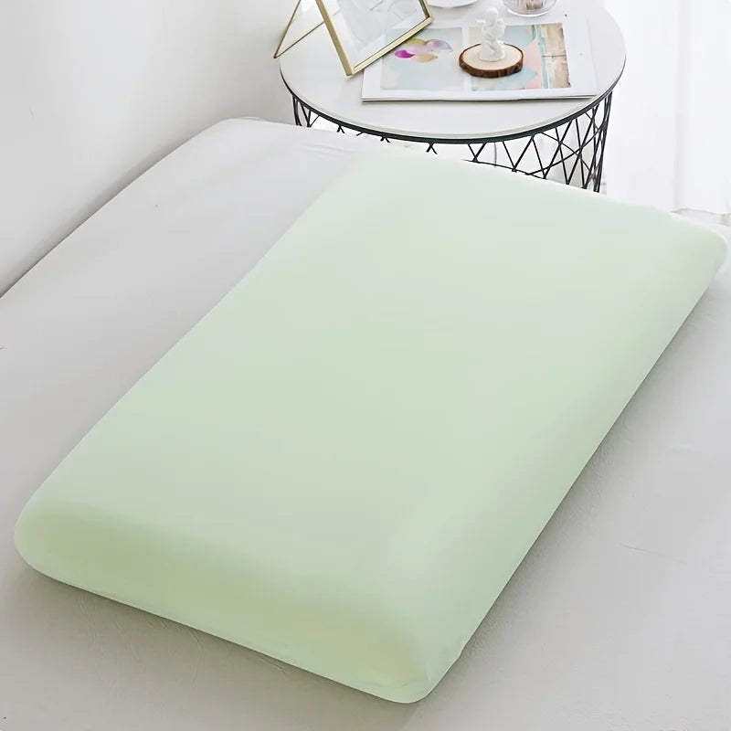 A light green ice silk cooling pillowcase resting on a white surface.