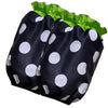 Black fabric ruffle apron with white polka dots and green trim