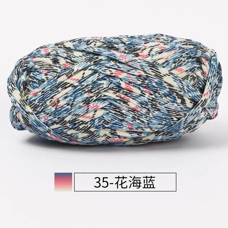 A ball of hand-dyed fabric strip yarn featuring a blue and white plaid pattern.