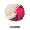 A ball of hand-woven chunky chenille yarn in white and pink colors.