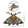 Embroidered patch of a colorful moth with patterned wings on a black background