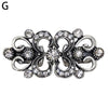 Silver vintage swirl clip brooch featuring clear rhinestones and intricate scrollwork.