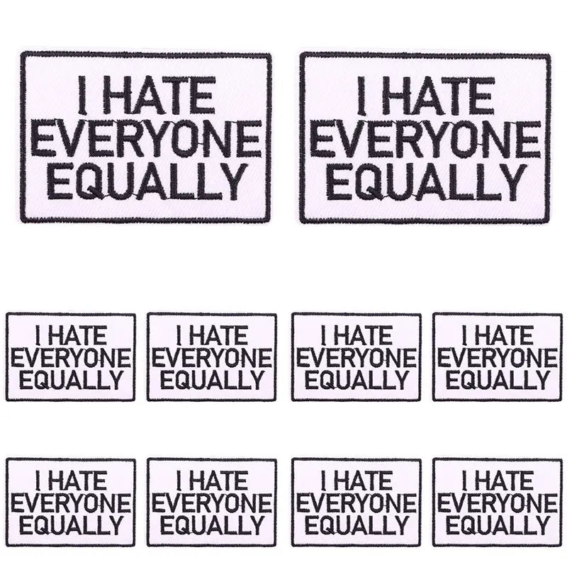 Four square patches with embroidered text that reads I HATE EVERYONE EQUALLY