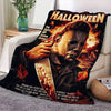 A dark Halloween themed blanket featuring a dramatic portrait of a man with fiery hair and intense expression.