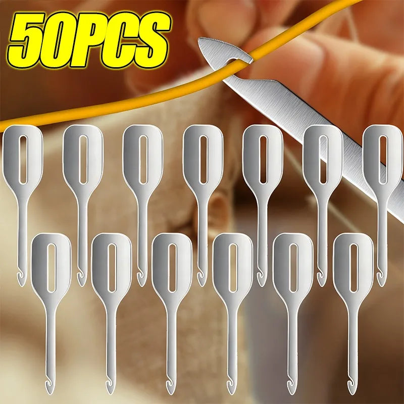A collection of 50 stainless steel needle threaders arranged in a row.