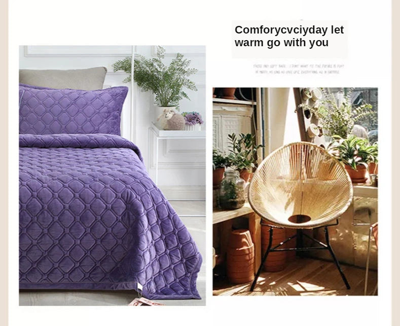 A purple plush velvet quilted bed cover blanket displayed next to a natural wood accent chair and potted plants.