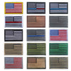A collection of various USA flag patches with hook and loop backing in different colors and designs.