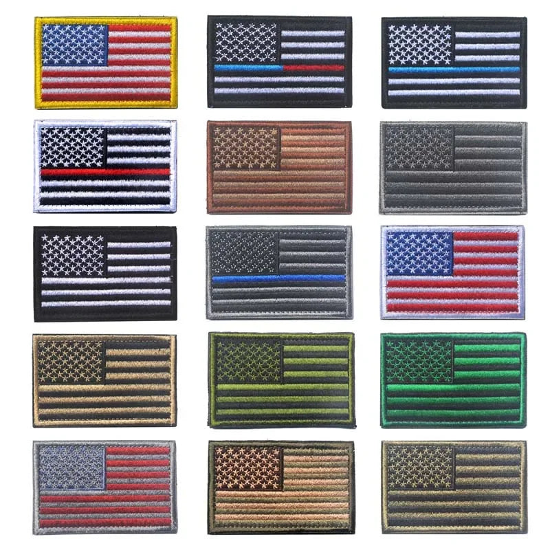 A collection of various USA flag patches with hook and loop backing in different colors and designs.