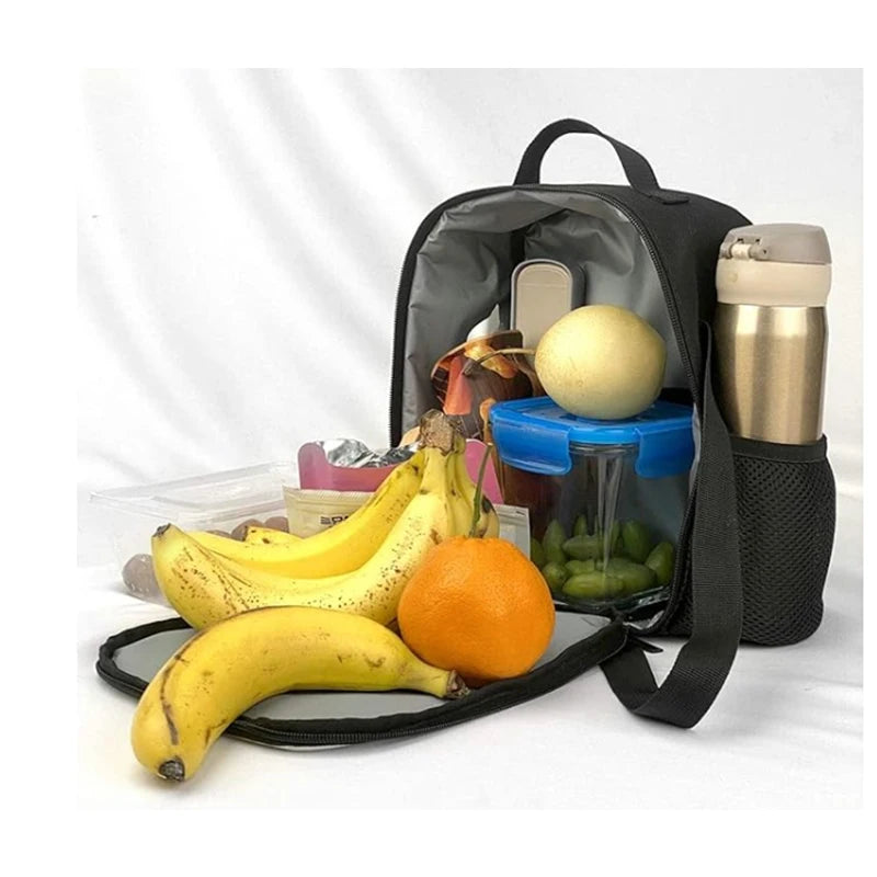 A black multi-compartment backpack set containing a yellow ball, an orange, and bananas.
