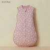A pink unisex cotton sleep sack for baby and toddler hanging against a light background.