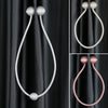 Magnetic curtain tiebacks in silver and rose gold tones used for elegant drapery