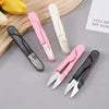 A set of five pink and black stainless steel sewing and embroidery scissors displayed on a light gray surface.
