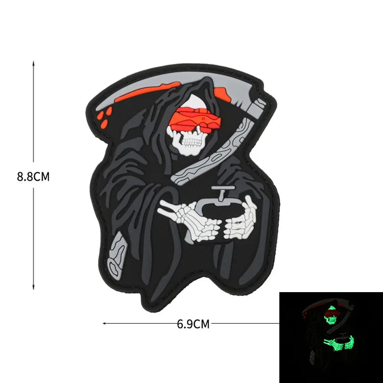 A black glow-in-the-dark biker patch featuring a skull design with red accents.