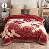 A deep red velvet weighted blanket featuring a floral pattern is displayed on a bed.