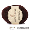 A ball of dark reddish-brown wool yarn with a label indicating delicate and soft intimate warmth.