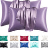 A collection of satin silk pillow covers in various shades including purple, green, pink, and white.