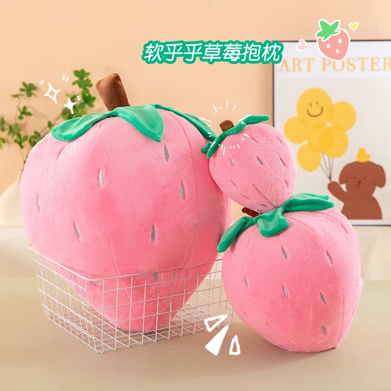 Pink plush strawberry throw pillows displayed in a wire basket on a light surface.
