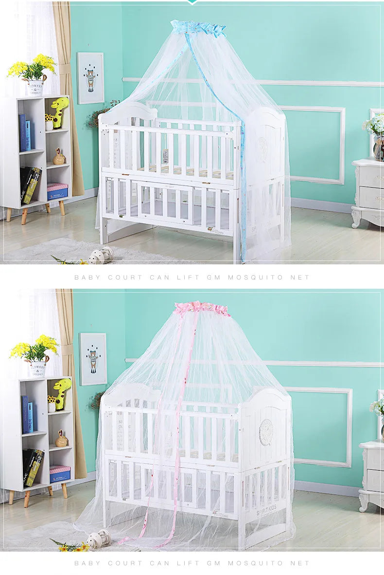 White infant cot with a sheer pink mosquito net canopy displayed in a light teal nursery room.