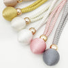 A collection of adjustable French ball curtain tiebacks in various colors including gold, lime green, white, pink, and gray.
