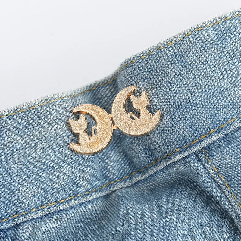 Gold crescent moon button clip attached to blue denim fabric