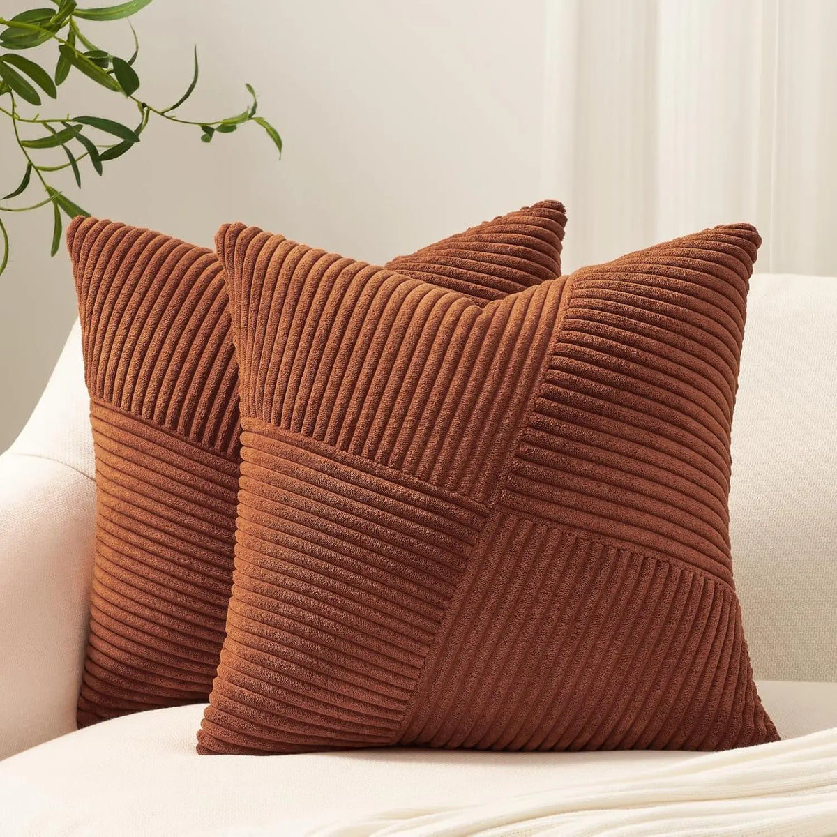 A textured brown corduroy throw pillow cover is shown resting on a white surface.