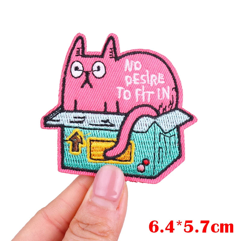Pink embroidered patch of a cat with text saying No Desire to Fit In