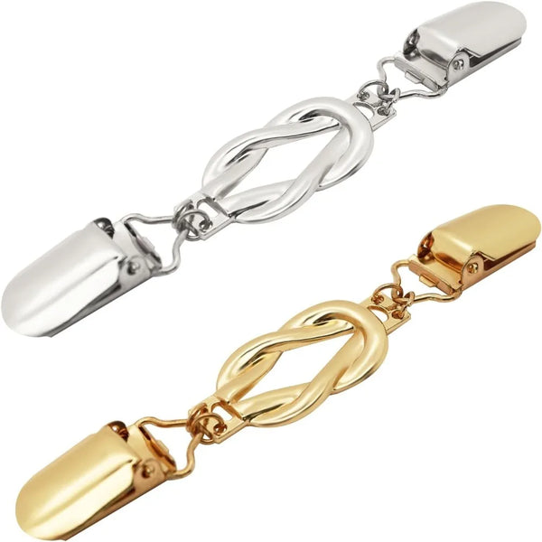 A pair of versatile garment clinching clips, one silver and one gold-toned.
