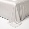 A white luxury Egyptian cotton bed sheet draped elegantly on a surface.