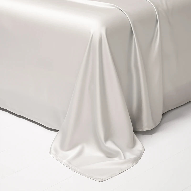 A white luxury Egyptian cotton bed sheet draped elegantly on a surface.