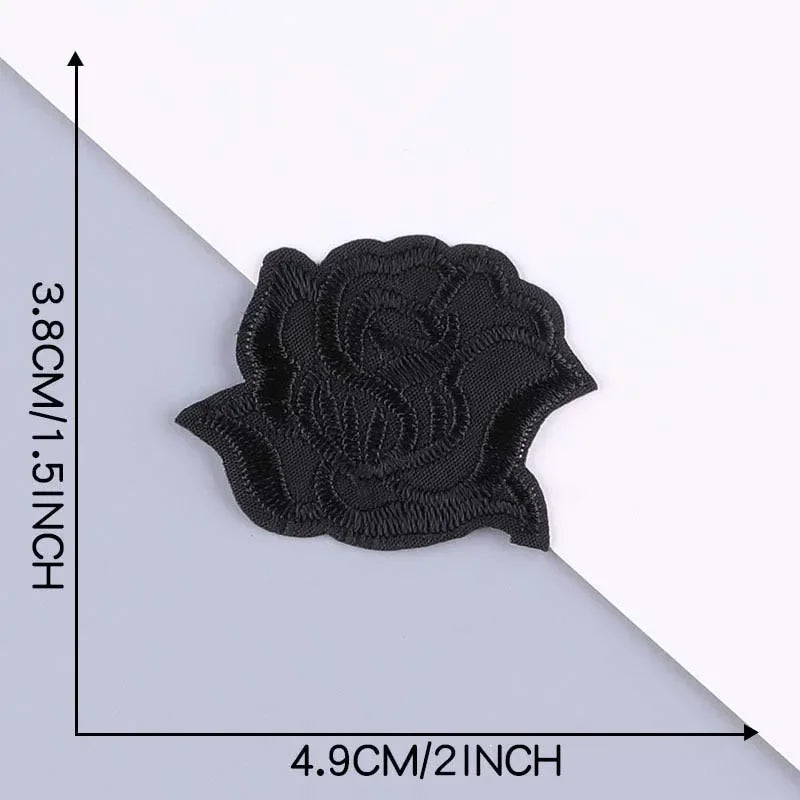 A black embroidered leather patch with a self-adhesive backing shown against a white background.