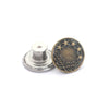 A round, antique brass metal button with a wreath design and five stars.