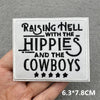A white embroidered patch featuring the text Raising Hell with the Hippies and the Cowboys
