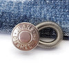 Silver metal button with the engraved text JEANS HENSHEN used for flexible waist extenders.