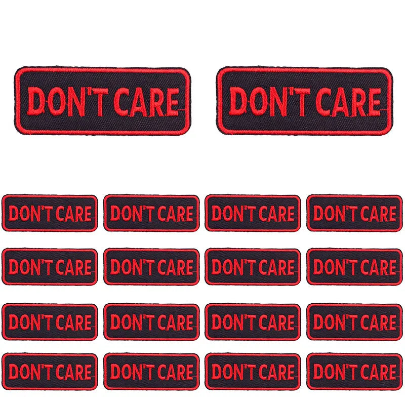 A collection of black and red embroidered patches with the text DON'T CARE.