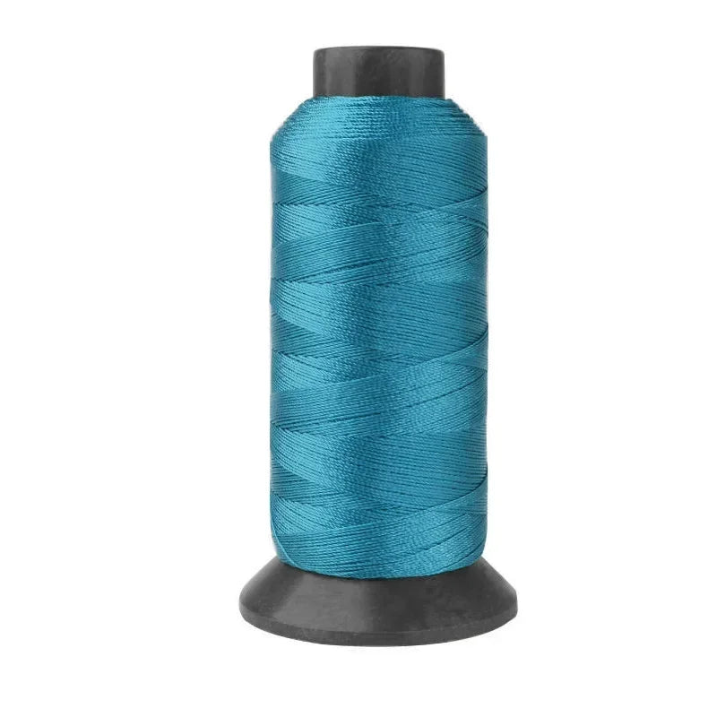 Roll of heavy duty 3-ply nylon sewing thread in teal color