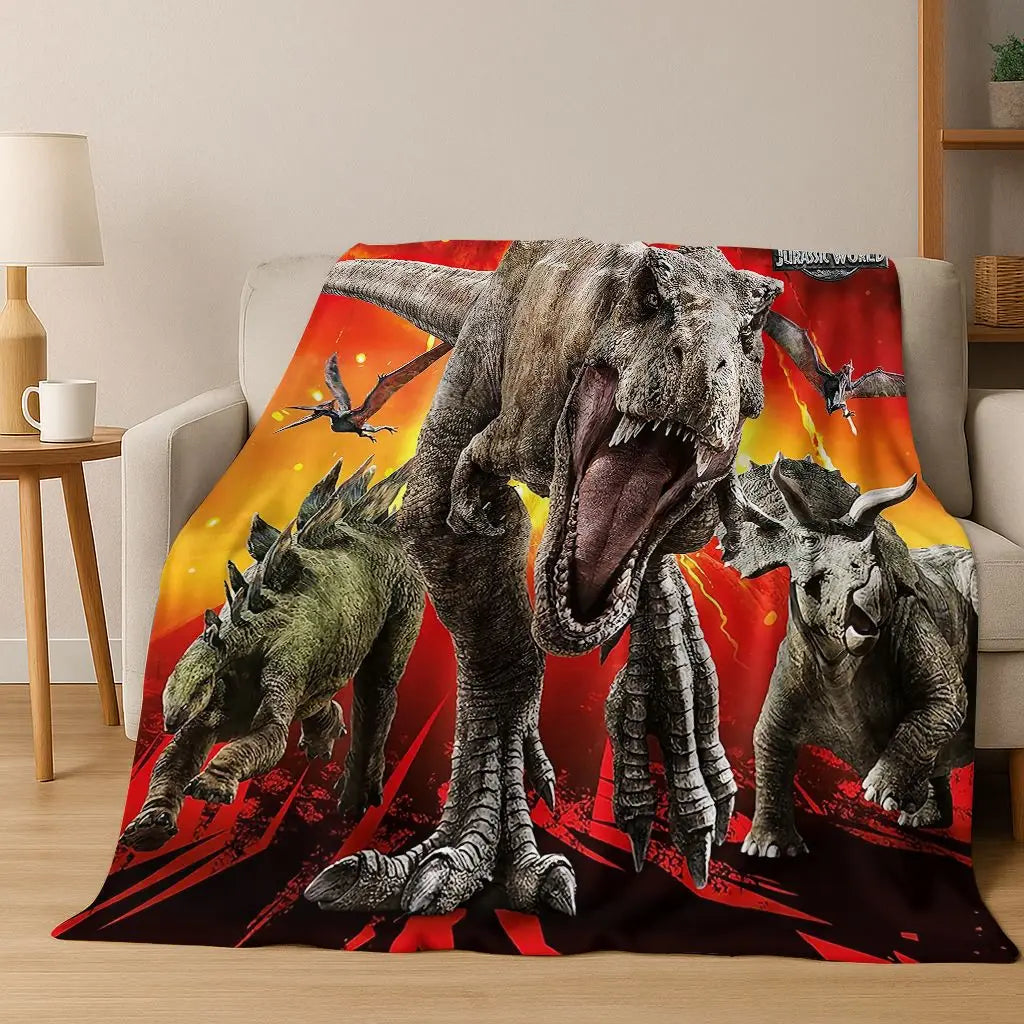 A graphic print of a Tyrannosaurus Rex and Triceratops dinosaurs on a blanket.