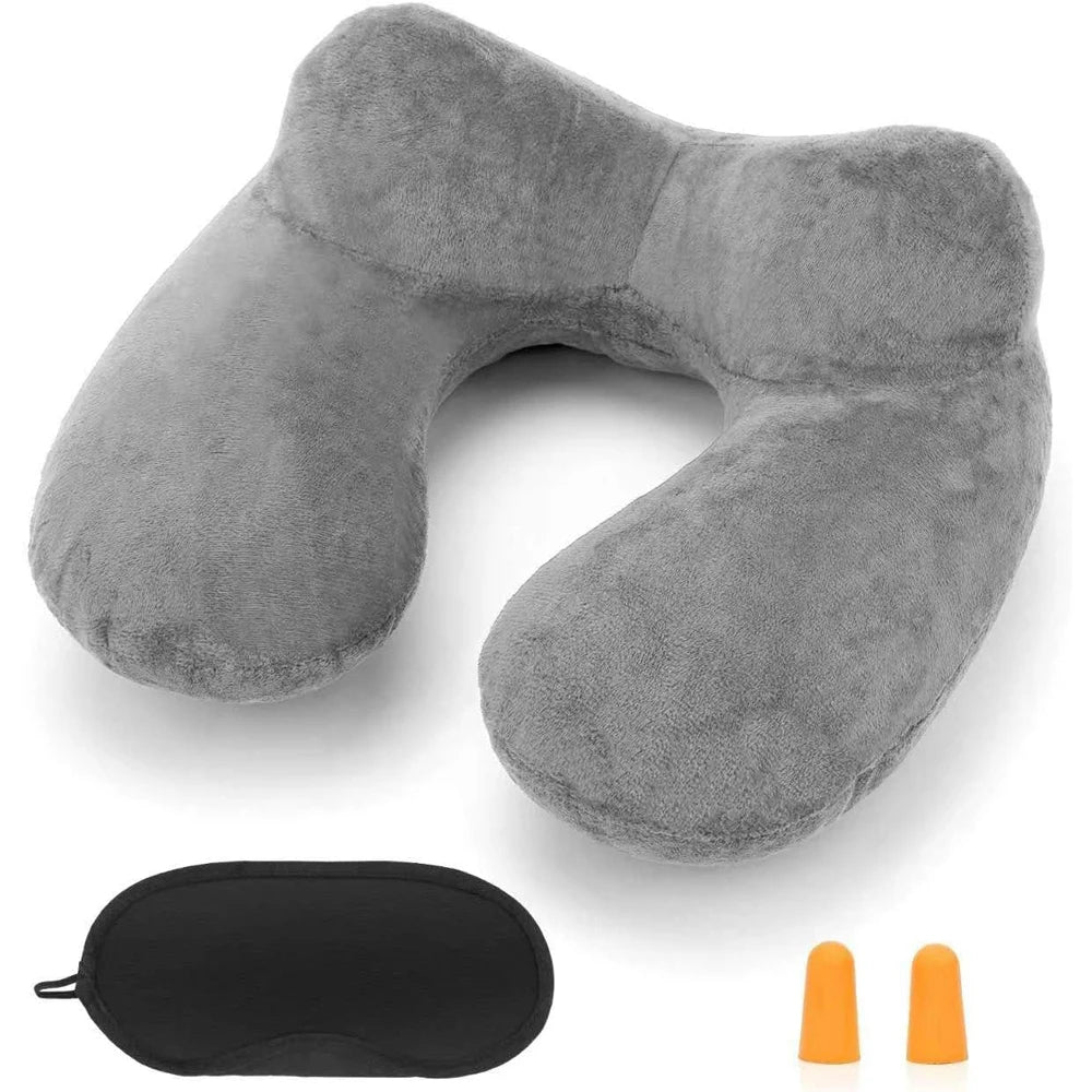 A gray inflatable travel pillow with a soft velvet cover and an orange accessory.