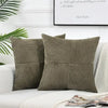 A set of retro corduroy patchwork pillow covers in olive green and beige tones displayed on a white sofa.