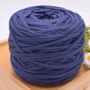 A ball of dark blue craft yarn for knitting and DIY displayed on a wooden surface.