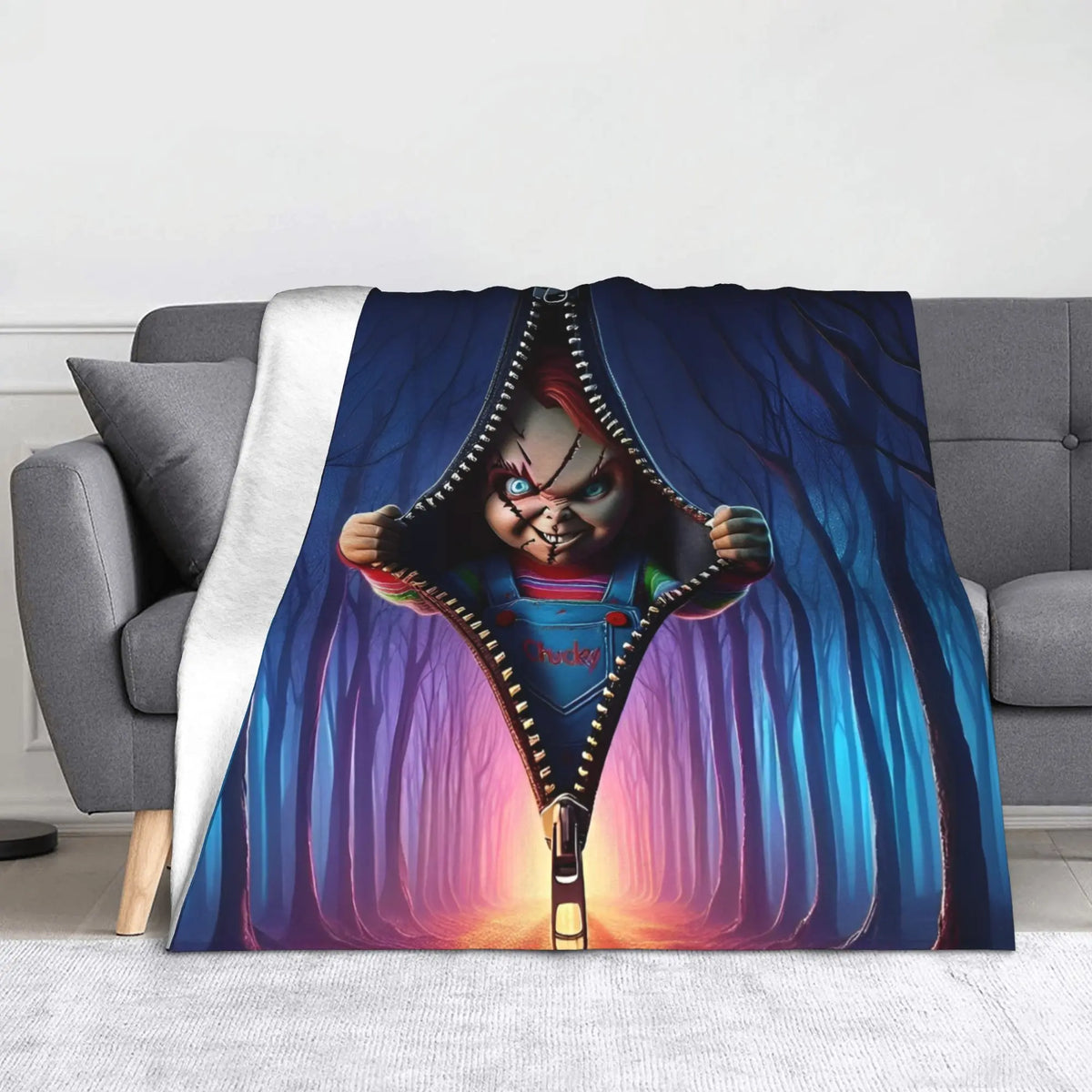 A flannel throw blanket featuring a graphic design of Chucky with a knife and a distressed look.
