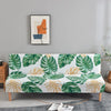 Geometric print spandex slipcovers for sofa beds featuring green and orange leaf patterns on a sofa.