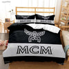 Black and white duvet cover set featuring the acronym MCM design on a bed.